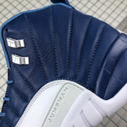 Close-up of the dark indigo stitched upper, metallic lace hardware, and raised Jumpman side-panel detail.