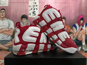 Pair of red and white Nike Air More Uptempo sneakers shown from the side