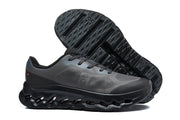 Dark charcoal and black On Cloudtilt Remix sneakers, with one shoe showing the patterned outsole.