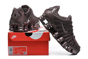 Dark brown Nike Shox TL sneakers displayed on a Nike shoe box; the box label shows size 8.
