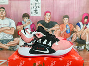 Side profile highlighting the pink upper, black tongue and laces, patterned side panel, white midsole, and Nike Swoosh.