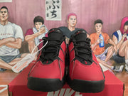 Front view of black and red Nike sneakers with black laces, perforated toe panels, and visible Nike branding.