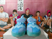 Front view of the blue basketball shoes with layered uppers and aqua toe outsoles
