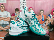 Angled view of the pair highlighting the patterned upper, teal laces, side branding, and green outsole.