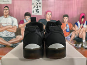 Rear view of black Jordan basketball sneakers showing heel branding and white accents.