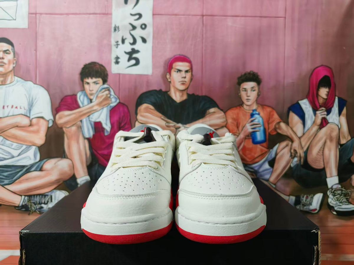 Pair of white low-top sneakers with red accents, shown from the front.