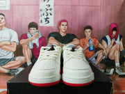 Pair of white low-top sneakers with red accents, shown from the front.