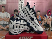 Pair of white and navy Nike sneakers shown at an angle