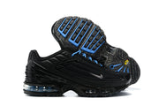 Side and outsole views of black Nike Air Max Plus sneakers with blue accents and visible cushioning.
