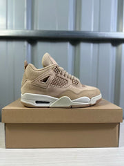 Clean lateral side profile of a tan Jordan 4 Retro sneaker on a shoebox.