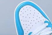 Close-up of the white perforated toe box framed by blue overlays.