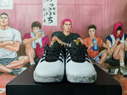Front view of the pair showing white toe boxes, black rope laces, black collars, and gold tongue details.