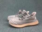Three-quarter view of the pair, highlighting the gray patterned upper and translucent gum-colored outsole.