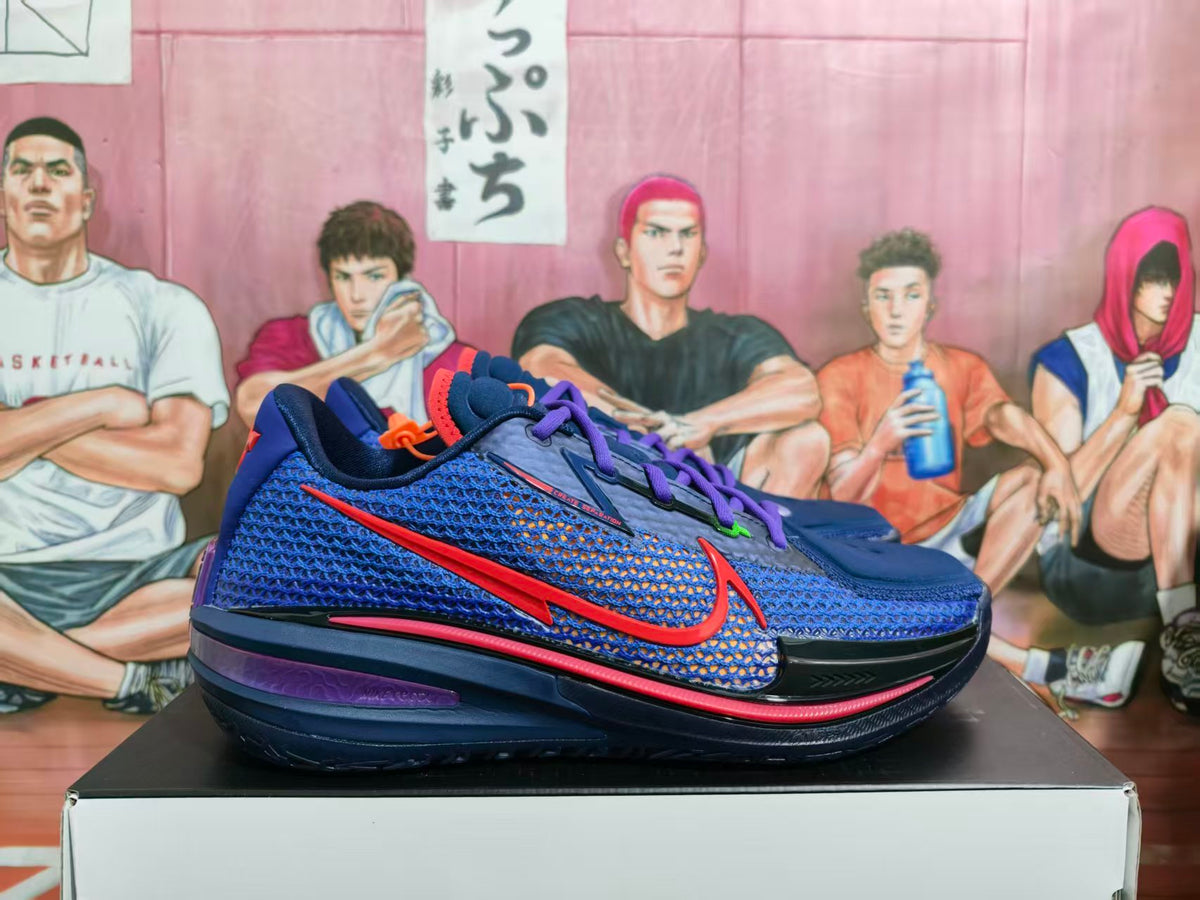 Side view of dark blue Nike GT basketball sneakers with purple laces, red accents, and a textured upper.