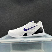 Side profile of a white basketball shoe with purple Swoosh detailing and a speckled midsole