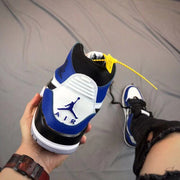 Rear view showing the blue collar, white heel panel, black detailing, and visible heel unit.