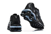 Rear and outsole views showing the heel columns and tread of black Nike Shox R4 sneakers.