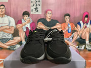 Front view of the black and grey Nike basketball sneakers showing black laces, mesh toe areas, and contrasting midsole sections.