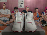 Front view of white and gray high-top Jordan sneakers with white laces and red Jordan tongue branding.