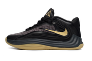 Side profile of a black and gold Nike Giannis Immortality 7 basketball shoe