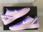 Overhead side view of the sneakers displaying the gradient uppers, checkerboard heel inserts, and pink midsoles.