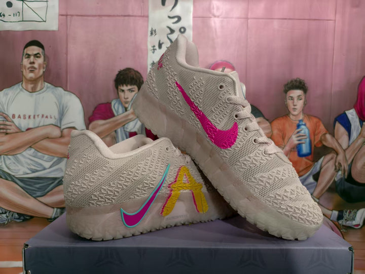 Pair of pink and white basketball sneakers showing the colorful side details and contrasting swooshes.