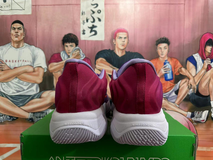 Rear view of purple and burgundy Nike basketball shoes with white outsoles.