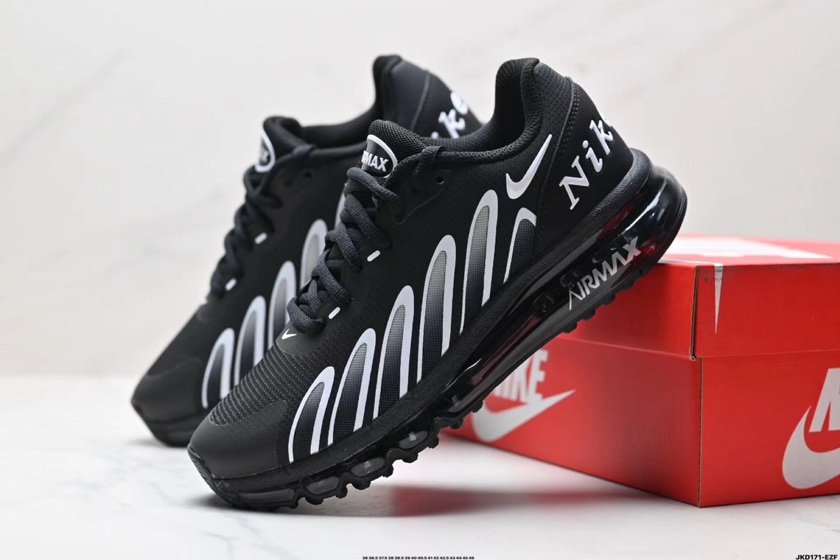 Black Nike Air Max-style sneakers with white side graphics beside a red shoe box