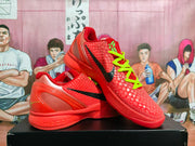 Angled view of red Nike Zoom basketball sneakers displaying the black side branding, textured upper, and layered midsole.