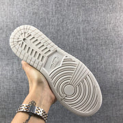 Close view of the light-colored rubber outsole with circular and linear traction patterns.