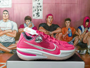 Side view of pink Nike basketball sneakers with a silver Swoosh and mesh-like panels