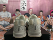 Rear view showing padded heel collars, gray upper panels, and black vertical heel detailing.