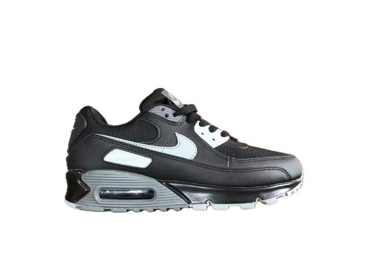 Side view of a black Nike Air Max-style low-top sneaker with grey panels, a white Swoosh and grey outsole accents.