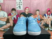 Front view of a pair of blue Nike shoes with laces and white outsoles.