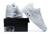 White Nike Air Max 90 sneakers displayed with a black box; the box label shows a sample size.