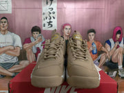Front view of brown Nike sneakers with laces and contrasting white soles.