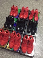 Angled overhead view of red and black high-top sneakers with matching laces.