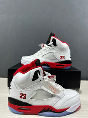 Close three-quarter view of the white, red, and black high-top sneaker with mesh side panel, number 23, and sculpted midsole.