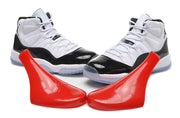 Front view of the pair showing white laces, glossy black toe overlays, and translucent outsoles.