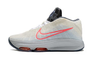 Side profile of light gray Nike GT Hustle 3 with coral Swoosh and dark patterned tongue.