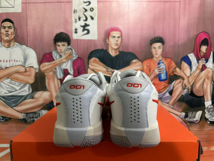 Rear view of white and red Nike basketball shoes showing heel panels and perforations.