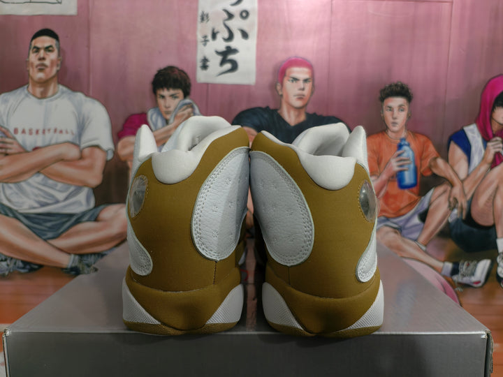Rear view of white and wheat high-top sneakers displayed on a shoebox.