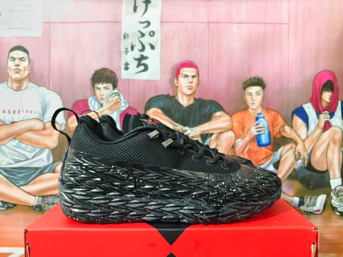 Side view of black Nike basketball shoes with a white-speckled angular sole.
