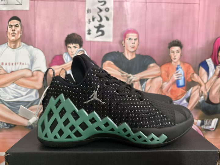 Side view of black Jordan basketball sneakers with green geometric side detailing and visible Jumpman branding.