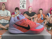 Side view of a coral and lavender Nike basketball shoe with a black Swoosh.