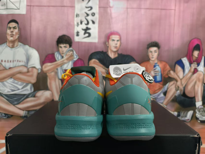 Rear view of multicolor Jordan basketball sneakers showing teal heels, gray heel panels, and orange trim.