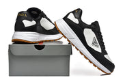 Black and white Prada-branded low-top sneakers shown with a shoe box.