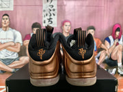 Rear view of the bronze and black sneakers showing black collars, pull tabs, and embroidered heel details.