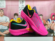 Side view of pink and black Nike GT Cut basketball shoes with teal-trimmed Swoosh logos.