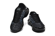 Pair of black Nike Air Max Plus sneakers viewed from above, showing the laces, toe panels, and blue side lettering.